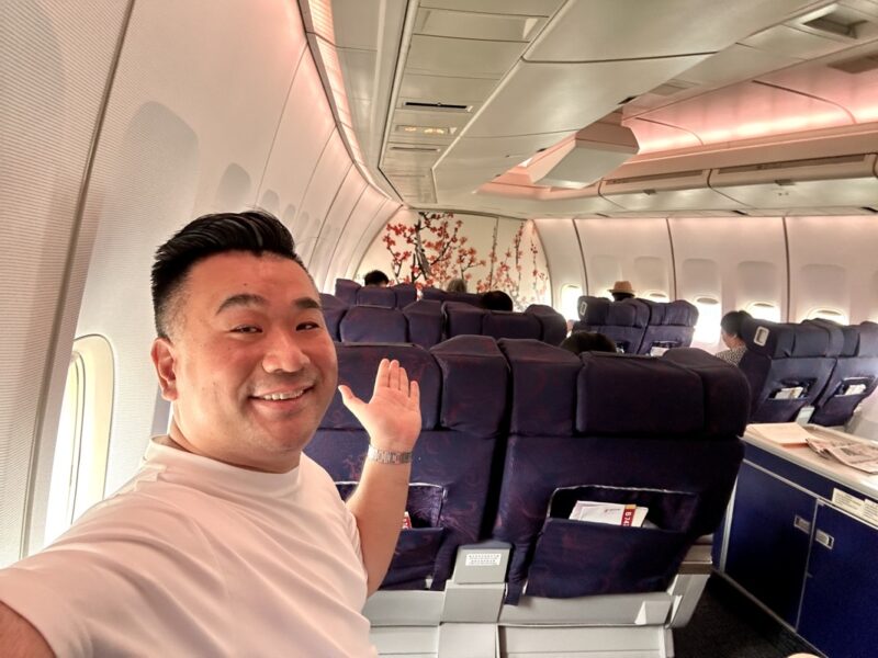 a man waving in an airplane
