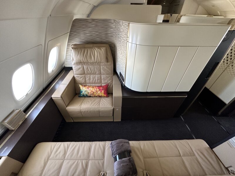 a seat and a couch in an airplane