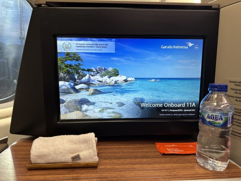 a tv screen with a water bottle and a towel on a table