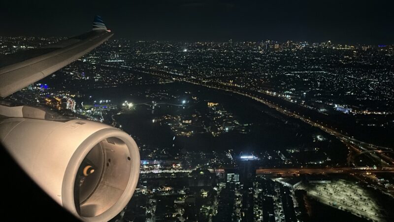 an airplane wing and city at night