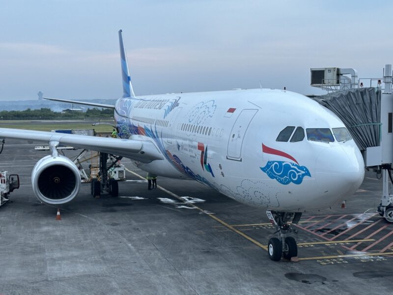 a large white airplane with blue and white design on it