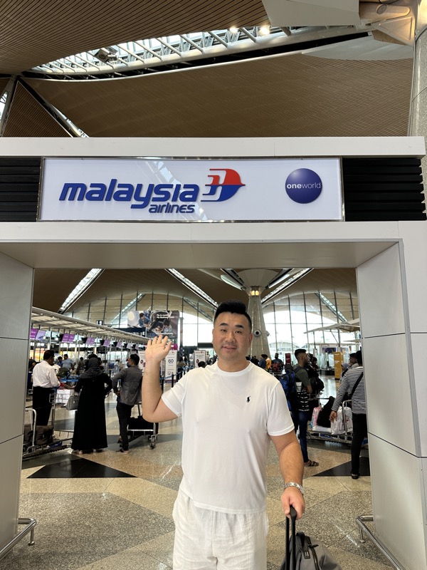 a man waving in an airport