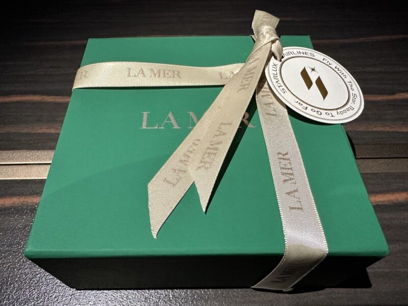 a green box with a ribbon and a white circle