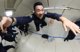 a man in uniform jumping in a room